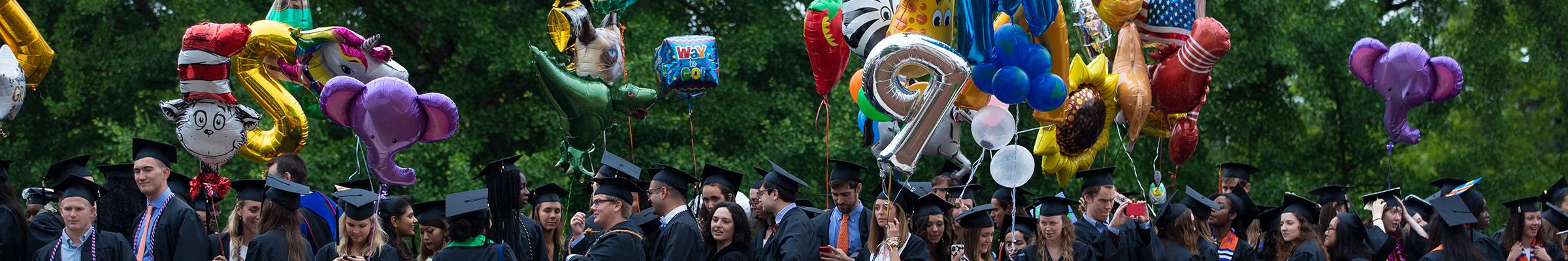 A banner featuring a portrait of students in their gowns on graduation day.