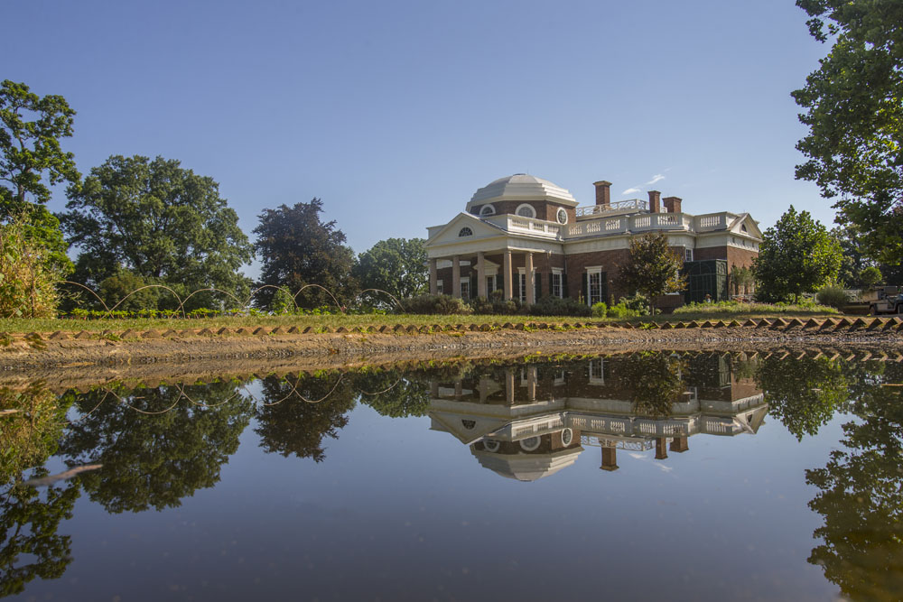A portrait of Monticello with its shadow reflected on the water.