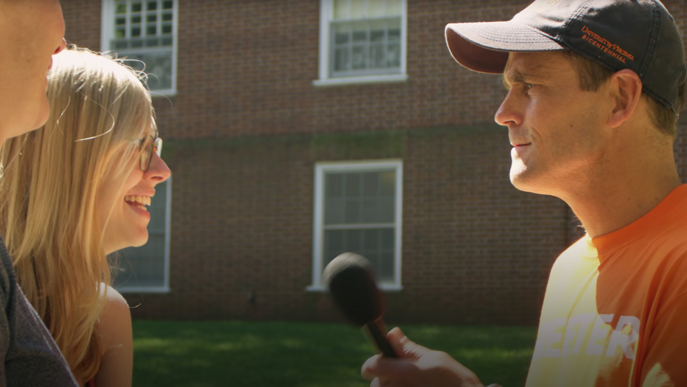 A portrait of President Ryan speaking with a student's parent during move-in day.