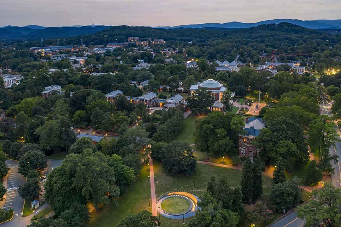 Portrait of UVA Lawn from an aerial view, with lights on at dusk.